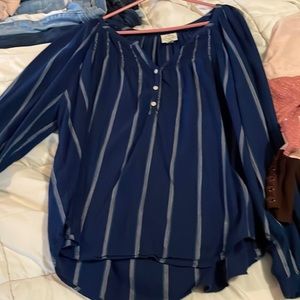 Shirts one blue with stripes and the other is pink and purple